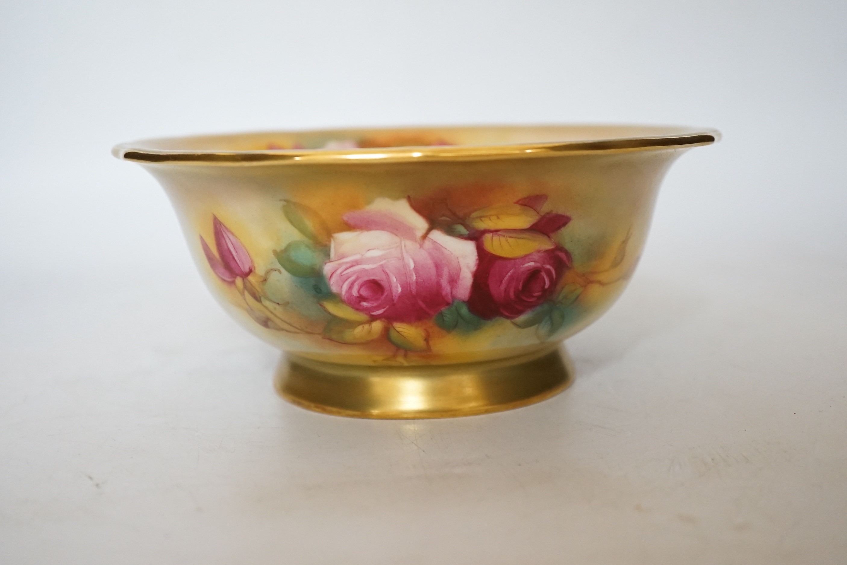 A Royal Worcester bowl decorated with roses, signed M Hunt, 8cm